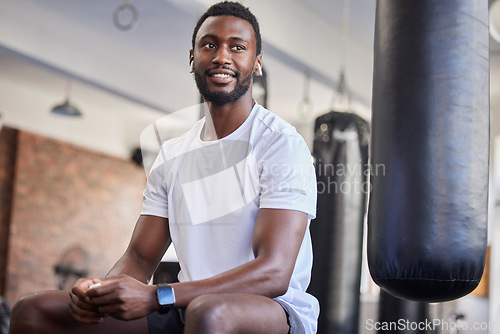 Image of Black man, fitness and wellness training gym break of an athlete ready for sport exercise. Workout, sports and relax man after boxing and strong bodybuilder set with a smile in a health club