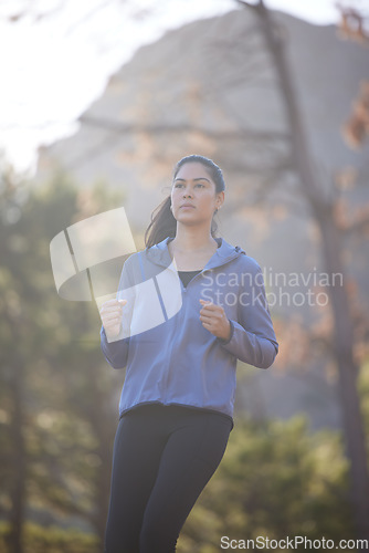Image of Woman, running and runner on nature run in forest for healthy fitness exercise, outdoors cardiovascular workout and sports training. Jog in green woods, natural trees and motivation for cardio health