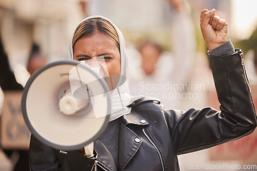 Image of Freedom, megaphone and fist with muslim woman in protest for support, social justice and human rights activist. Politics, revolution and equality with hijab girl in crowd for discrimination fight