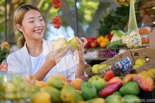 Image of Woman, fruit and grocery shopping in outdoor market, pear choice and health product with food and nutrition in Seoul marketplace. Store, happy Asian customer and retail with sale, vegetable and smile