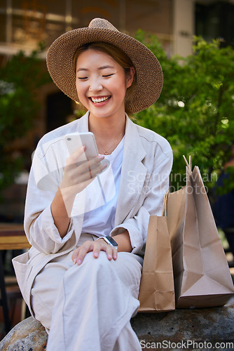 Image of Shopping, city and woman in Japan with smartphone for ecommerce website, fintech and internet deal on sales, product promotion and discount. Cellphone, asian or Japanese girl and shopping bag at mall