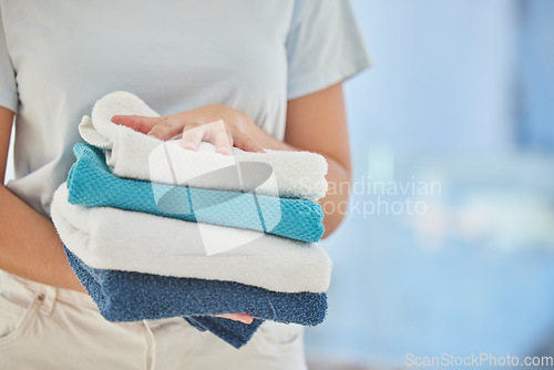 Image of Clean towels, hands and woman with laundry, linen and cotton textile in stack with mockup. Closeup cleaner, maid and fabric towel for spring cleaning services, hospitality and hotel room maintenance