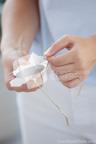 Image of Woman, hands or cleaning fabric for glasses in optometry clinic, ophthalmology help or fashion retail store. Zoom, optician or cloth wipe on vision lenses, medical prescription or hygiene maintenance