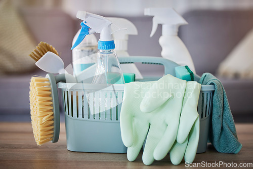 Image of Cleaning, products and basket on table in home living room for spring cleaning. Hygiene, cleaning supplies and housekeeping equipment for disinfecting, sanitizing or removing germs, bacteria or dust.