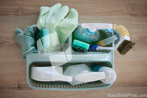 Image of Top view of cleaning, products and basket on table in home living room for hygiene. Spring cleaning, health or housekeeping equipment, tools or supplies to disinfect or remove dust, germs or bacteria