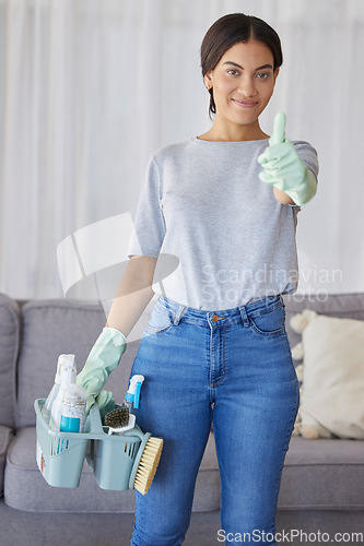 Image of Cleaner, thumbs up and portrait of a woman with supplies to clean the living room of a house. Happy, smile and female maid or housewife with a positive mindset for cleaning an apartment, loft or home