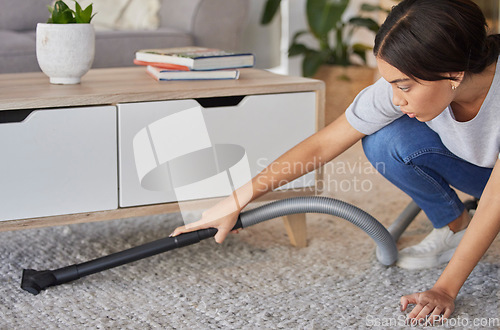 Image of Woman, cleaning and vacuum machine for carpet in house, home or hotel living room in hygiene maintenance or housekeeping. Maid, cleaner service or worker with suction on floor rug for spring cleaning