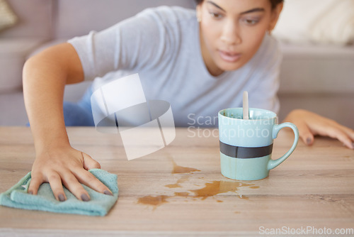 Image of Cleaning surface, coffee spill and woman wipe furniture, coffee table and counter in living room with cloth. Housekeeping, hygiene and young woman with rag for liquid mess, dirt and stain from tea