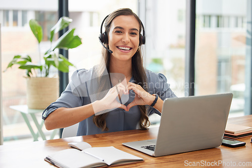 Image of Woman, call center and laptop with heart gesture for telemarketing, customer service or support at the office. Portrait of happy employee consultant with smile and hands with love symbol by computer