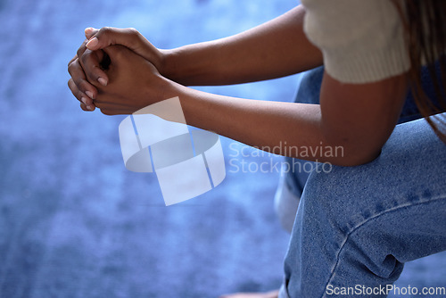 Image of Woman, hands or nervous on sofa in house, home or psychology counseling for mental health, depression or bipolar disorder. Stress, anxiety or impatient person on couch in living room burnout or fear