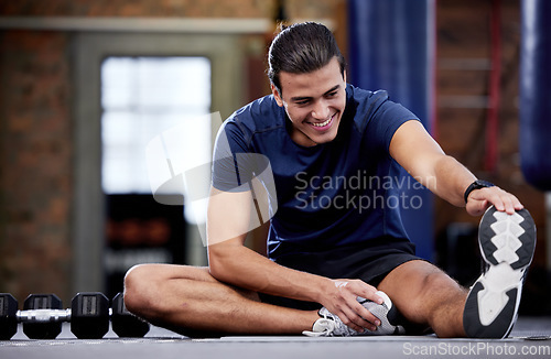 Image of Fitness, man and stretching legs in gym for health, mobility and flexibility. Sports, wellness and happy male warm up or preparing for training, exercise or workout in fitness center for healthy body