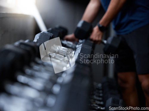 Image of Man, hands or dumbbells in gym workout, training or exercise for strong muscle growth, healthcare wellness or bodybuilding. Zoom, texture or heavy metal weights for fitness coach or personal trainer