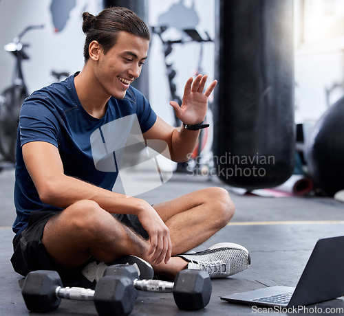 Image of Man, laptop and wave for video call in gym with smile rest on floor after training session. Guy, wellness and pc break during workout for fitness, health or sport with happiness on online webinar