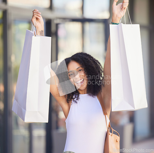 Image of Black woman portrait, celebration and shopping in city with bags, smile and sale for happiness in summer. Happy african woman, gift and discount while outdoor in metro, mall or street in Los Angeles