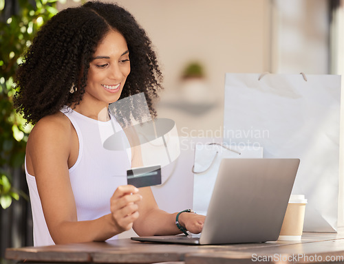 Image of Black woman, laptop and credit card for ecommerce, online shopping and making payment with fintech software while at a cafe with wifi connection. Female customer in Paris doing internet banking