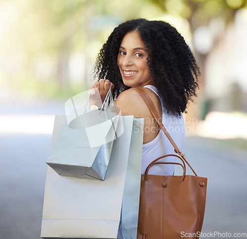 Image of Portrait, fashion and black woman with shopping bag in city after buying clothing at mall. Black Friday deals, sales discount or happy female shopper holding gifts after purchase at boutique or store
