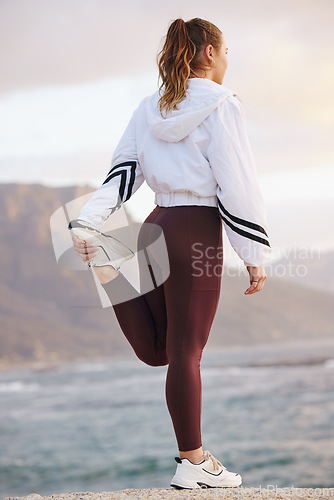 Image of Runner woman, stretching legs and beach for health, fitness and ready for training, exercise and run. Warm up, ocean running or muscle development in workout, wellness and focus for girl in Vancouver