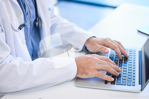 Image of Doctor, laptop and hand typing email or prescription online for medical treatment in a clinic or hospital. Healthcare, medicine and keyboard with a cardiologist type a research report on the internet