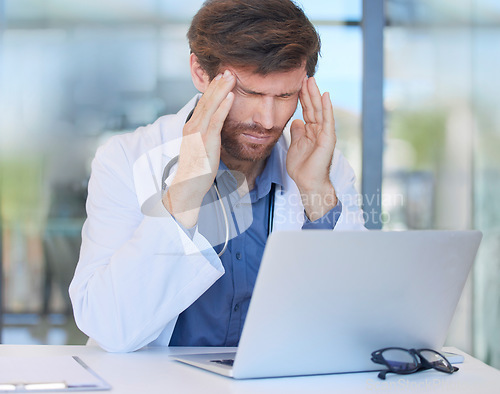 Image of Headache, burnout and doctor in hospital office feeling pain or migraine while working on laptop. Mental health, anxiety and medical physician from Canada with stress or depression after surgery fail