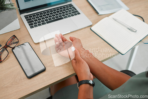 Image of Wrist, arm and pain by laptop desk of employee worker suffering from carpal tunnel syndrome at the office. Person hand holding painful area, inflammation or sore muscle ache from working on computer