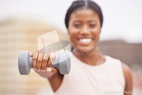 Image of Dumbell, exercise and black woman does fitness workout for muscle growth, body health and strength training on a blurred background rooftop. Sports athlete, healthy and strong African American girl