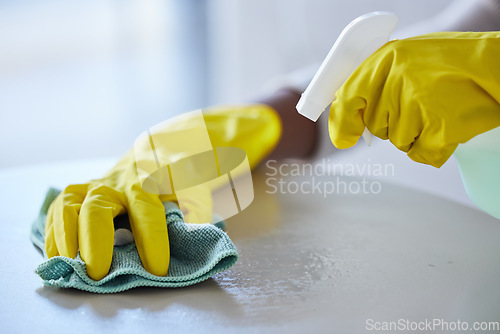 Image of Cleaning, housekeeping and hands with cloth and spray bottle to wipe, disinfect and clean furniture. Housework, spring cleaning and rubber gloves with detergents, cleaning products and chemical spray