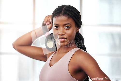 Image of African woman, gym portrait and kettlebell for training, weightlifting or summer body for focus on goals. Black woman bodybuilder, strong or mindset for fitness goal, self care or wellness in Atlanta