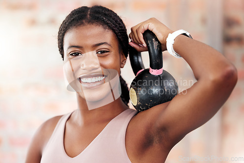 Image of Black woman, face and smile for kettlebell exercise for bodybuilder workout, fitness and training at gym for strong muscles, health and wellness. Portrait of US female with weights to train for power