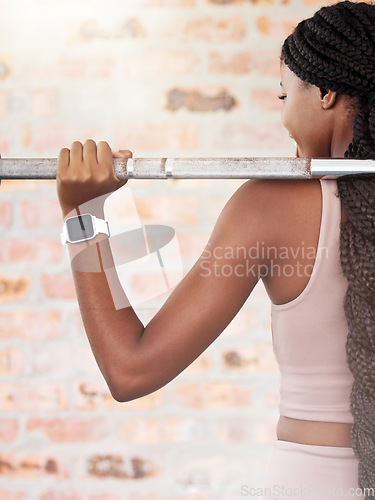 Image of Back, black woman and lifting for exercise, workout and training for health, wellness and power. Jamaican female, healthy lady and athlete weightlifting, practice and fitness for endurance and energy