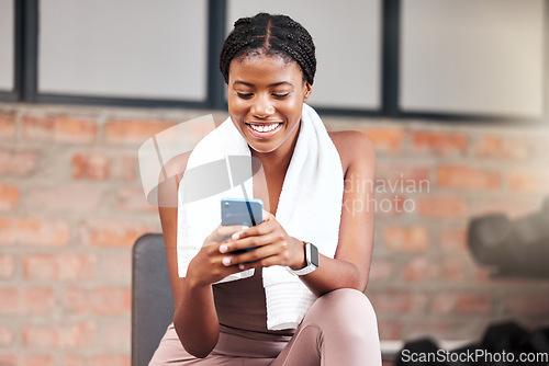 Image of Black woman, smartphone and exercise in gym, connection and social media. Jamaican female, athlete and phone for communication, relax and break after fitness, workout and training for health or smile