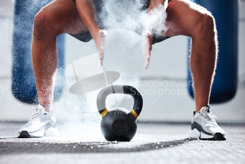 Image of Man, legs and kettlebell with fitness and bodybuilder hands with powder, exercise in gym for bodybuilding, strong and muscle training. Workout, sports motivation and health wellness with performance