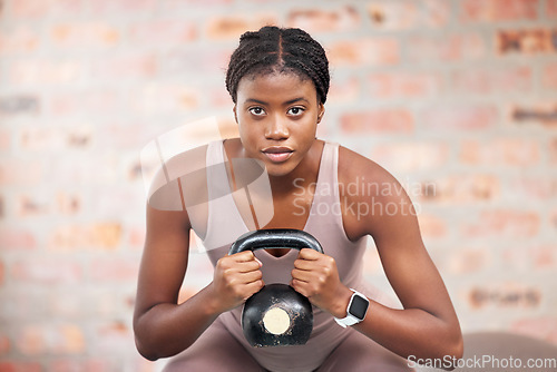 Image of Black woman, face and kettlebell in gym workout, training or exercise for body muscle growth, cardiology wellness or healthcare. Portrait, sports fitness and personal trainer weightlifting in Jamaica