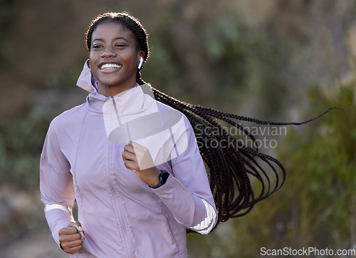 Image of Running, happy and black woman with music in nature, cardio fitness and sports health in mountains of Indonesia. Podcast, training and African athlete listening to radio while on a run in a park