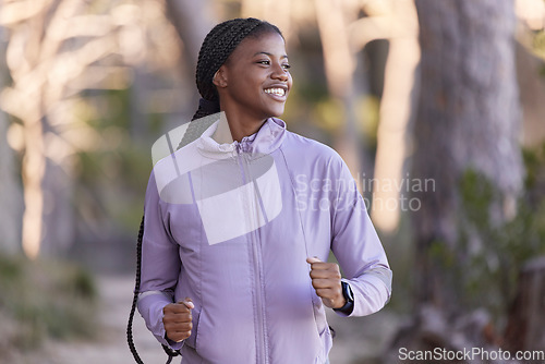 Image of Fitness, running and black woman smile on a sport run in forest park outdoor with happiness. Happy, African and exercise runner feeling freedom from cardio, marathon training and motivation in nature