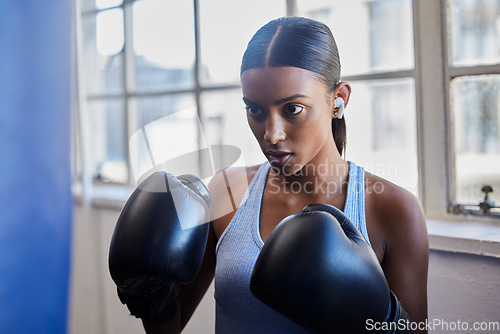 Image of Boxing, fitness and Indian woman in gym for training, exercise and kickboxing lesson. Sports, wellness and female athlete with boxing gloves for focus, determination and motivation for strong muscles