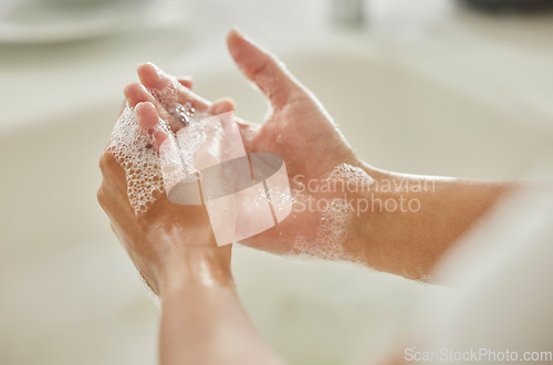 Image of Woman, cleaning and hands with soap, bubbles or water in bathroom for hygiene, healthcare or safety. Hand washing, foam and clean from germs, virus or bacteria for wellness, healthy skin or self care