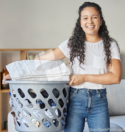 Image of Woman, portrait and laundry basket for cleaning and folding of clothing with happiness at home. Chores, washing and face of happy female with housework for tidy and clean clothes routine