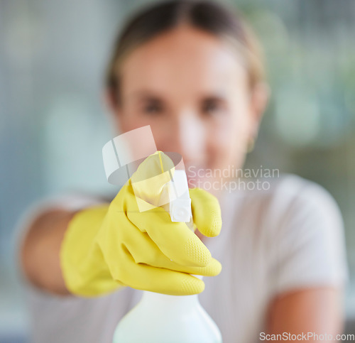 Image of Hand, spray bottle and cleaning with a woman in gloves for housework or sanitization for hygiene. Hands, latex and disinfectant with a female cleaner spraying product to clean for a fresh wash