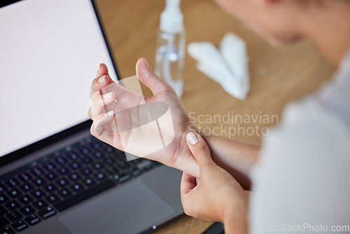 Image of Wrist, pain and woman at laptop working with injury, arthritis or carpal tunnel syndrome concern. Inflammation, uncomfortable and injured girl with medical problem at table with screen mockup.