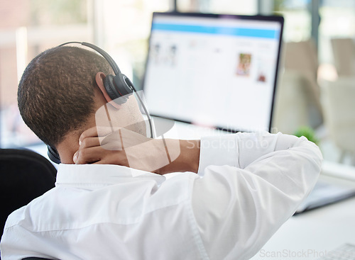 Image of Call center, advice and neck pain with a man feeling body ache while in a telemarketing and communication job. Burnout, stress and physical strain in a contact us, customer care and consulting agency