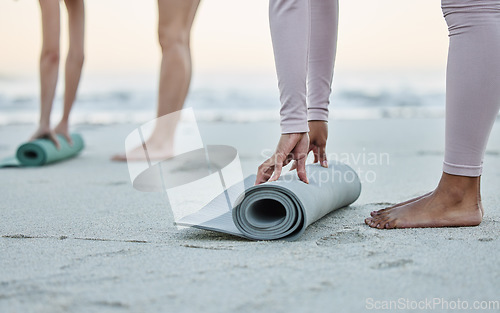 Image of Yoga, mat and beach with a woman athlete on the coast by the sea or ocean for fitness and exercise. Hands, earth and water with a female yogi training on the shore for wellness ot mental health