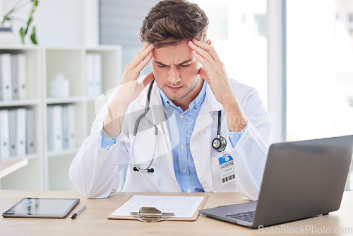 Image of Man, doctor or stress headache and clipboard paper, test results or life insurance documents in hospital office. Anxiety, thinking or burnout for healthcare worker with laptop technology or research