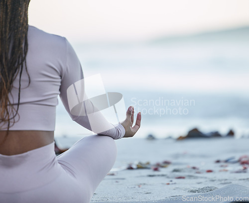 Image of Beach, yoga and lotus with black woman in meditation for calm, peace and zen with fitness, training and workout mockup. Ocean, waves and woman meditate on sand at sea for holistic exercise in nature