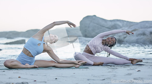Image of Beach, yoga and stretching women or team with fitness, exercise and cardio wellness, body goals and accountability in morning. Diversity, pilates and holistic sports people with collaboration by sea