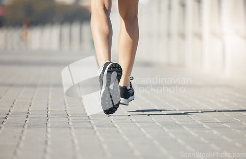 Image of Runner, feet and woman on path to run for fitness, training and outdoor city workout. Exercise, health and wellness, close up sports shoes, girl running with motivation for growth at race or marathon