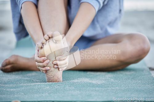 Image of Woman, injury and foot pain from beach yoga, exercise and health. Closeup female massage joint pain of bare feet, muscle and orthopedic accident, problem and podiatry risk from pilates workout at sea