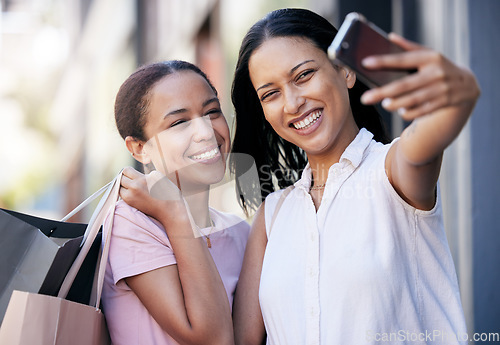 Image of Friends, smile and take a selfie on the street for social media after shopping for retail clothing, bonding together and new fashion trends. Black woman, happy at a mall and luxury designer clothes