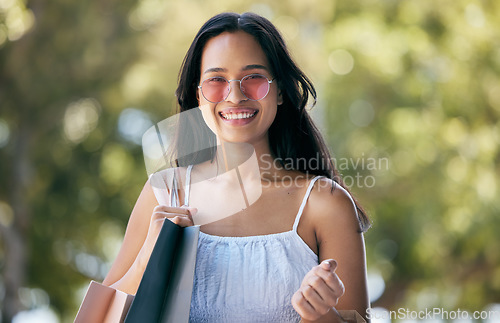 Image of Woman, portrait and shopping with shopping bag outdoor, fashion with designer brand and happy with discount sale. Customer, shop and mockup with travel in New York, purchase clothes.