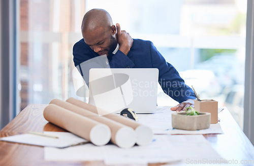 Image of Black man, business and neck pain in office, stress and overworked with laptop, documents and tired. Young man, Jamaican entrepreneur and architect with shoulder strain, burnout or frustrated at desk