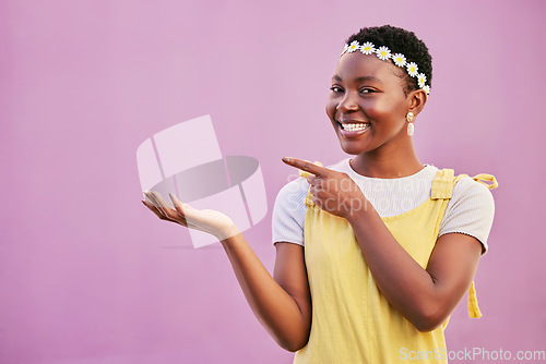 Image of Face portrait, black woman and pointing at mock up for marketing, advertising or promotion on a studio background. Product placement, branding and happy female model from Nigeria showing copy space.